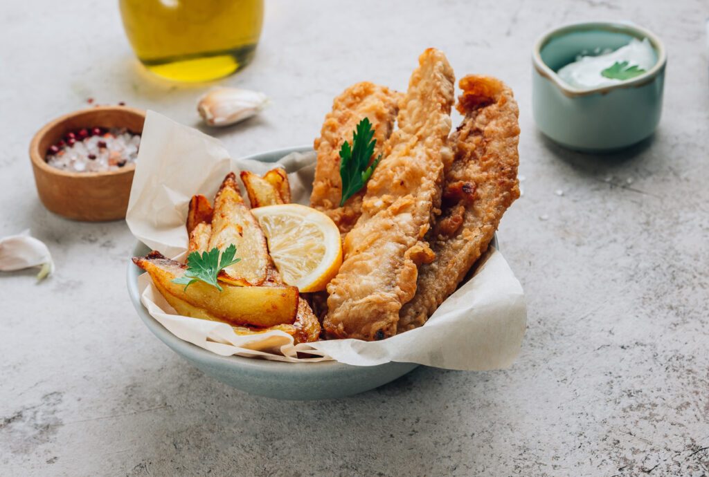 fish and chips on white table